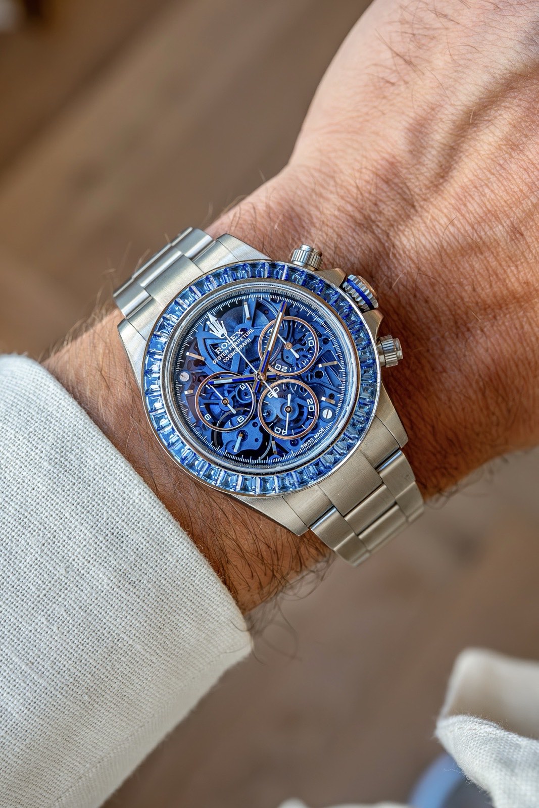 The Arolla Daytona on the wrist, its blue baguette-set bezel forming a continuous ring around the sapphire dial