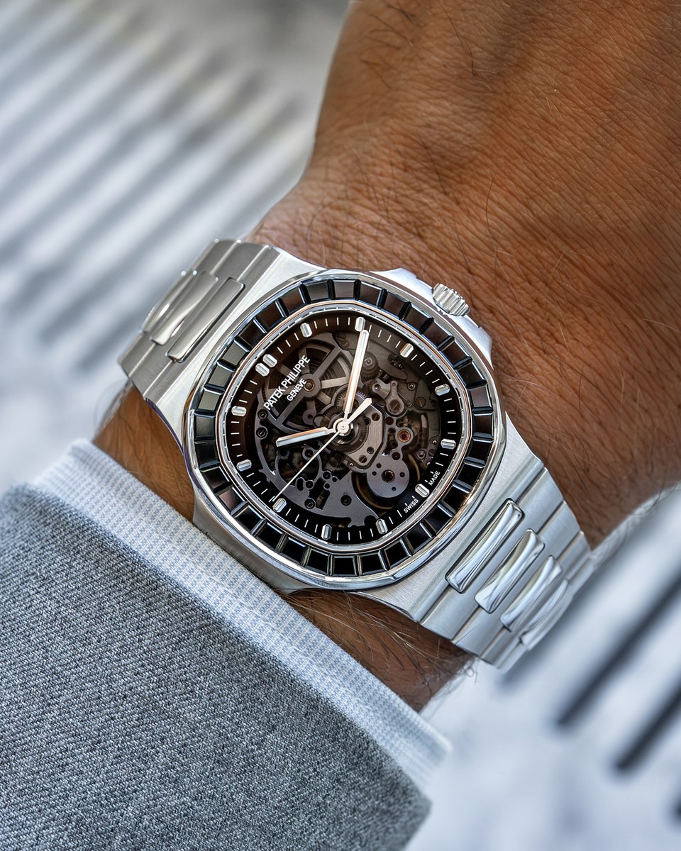 The Black Stone worn in daylight, a black spinel bezel around a smoky sapphire dial with the openworked calibre visible beneath