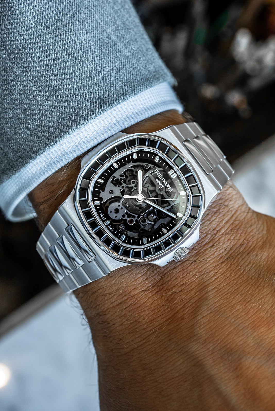 The Black Stone on the wrist beneath a pale blue cuff, with narrow blue reflections across its black spinel bezel