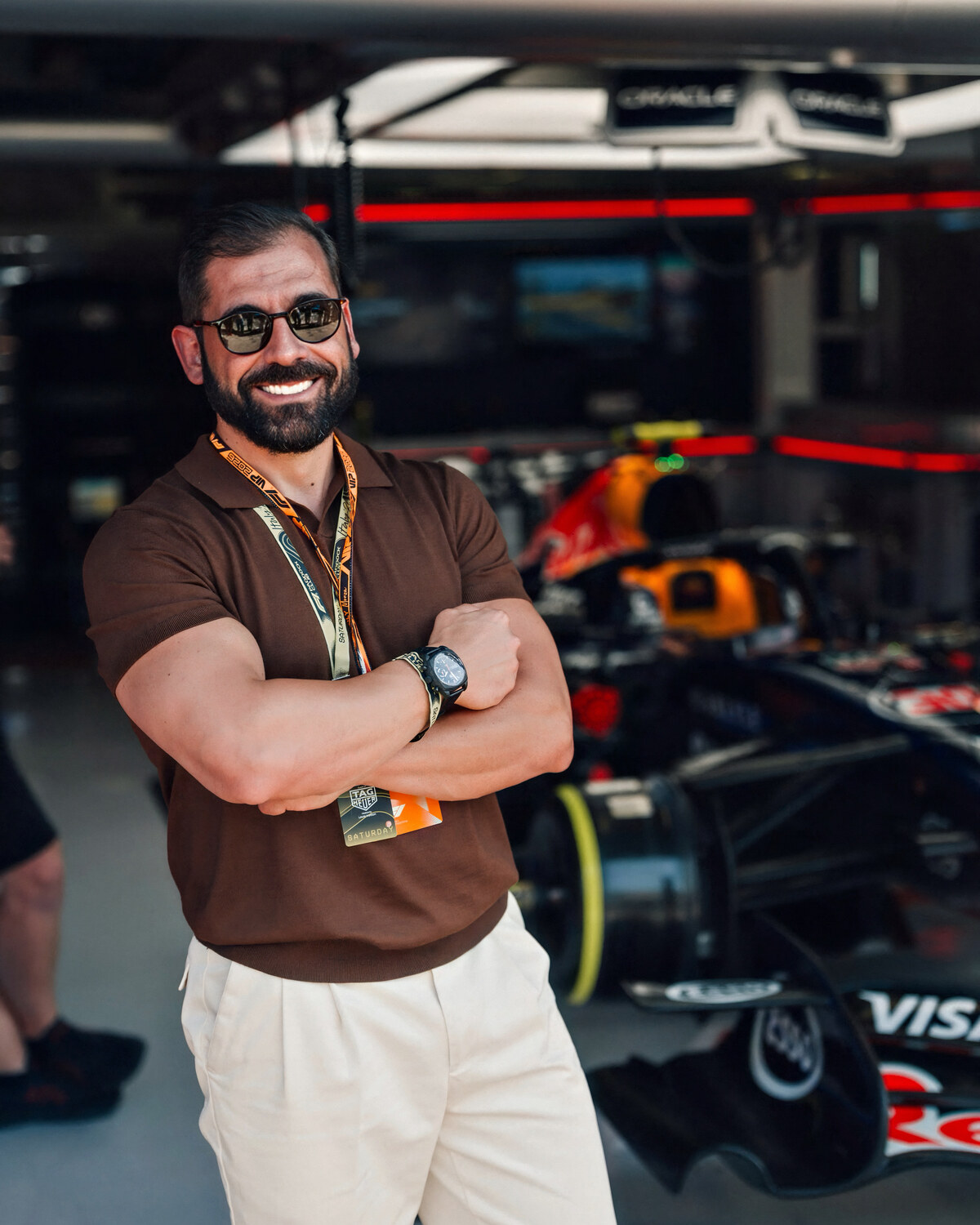 Gabriele Ciervo with his arms crossed inside the Oracle Red Bull Racing garage at Monza, the team car behind him