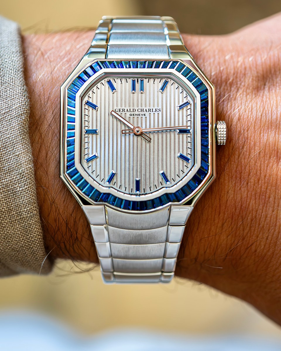 Gerald Charles Masterlink Gem-Set on a wrist: asymmetric steel case with clipped corners and a curved edge at six, bezel set with blue baguette sapphires, silver dial with applied vertical stripes and blue baguette indexes, integrated steel bracelet