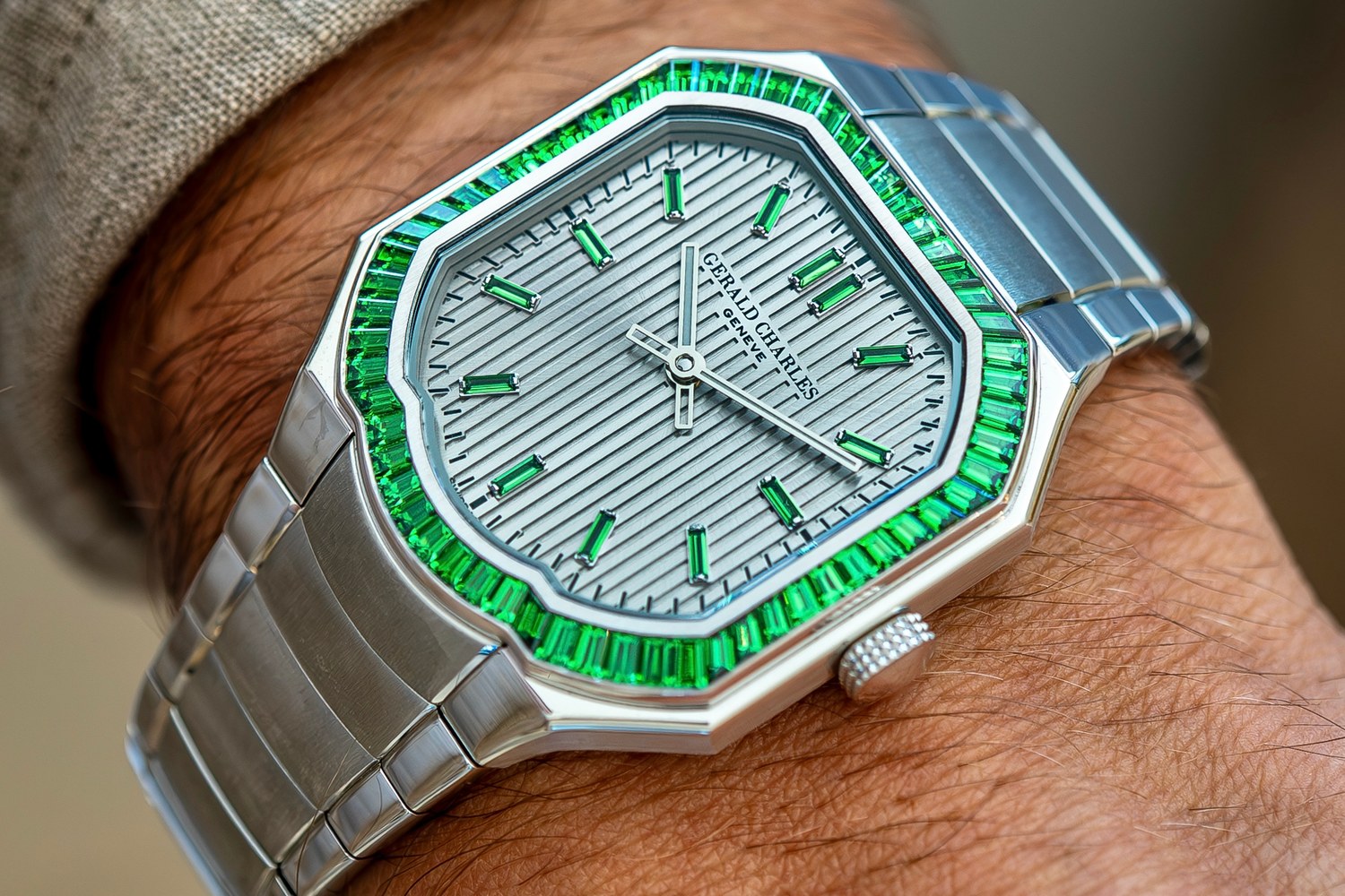 The green tsavorite Masterlink Gem-Set worn on the wrist, with its integrated steel bracelet, striped silver dial and green stone indexes visible