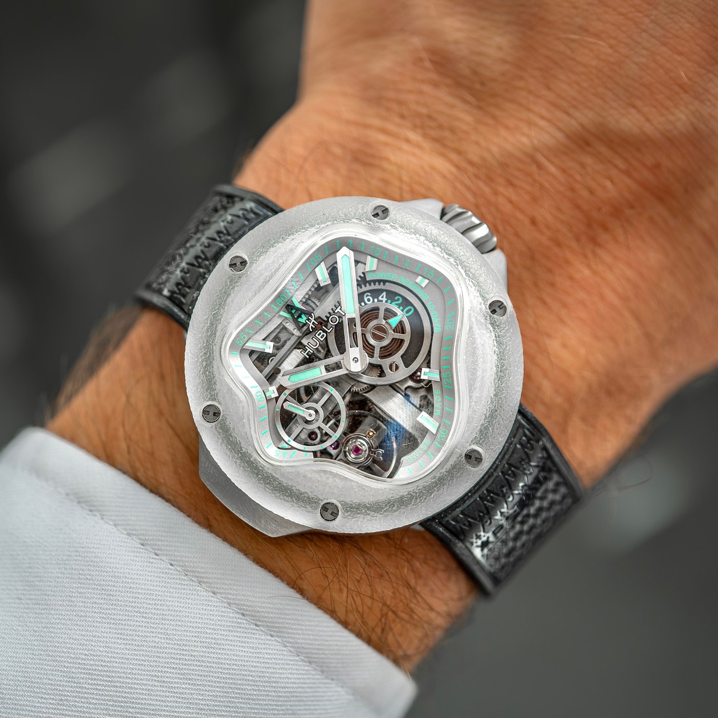 Close view of the MP-17's dial side: the splash-shaped aperture, skeleton bridges, green luminous hands and the small seconds