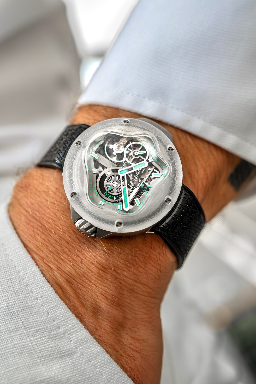 The Hublot MP-17 Arsham Splash on a wrist under a white shirt cuff: frosted sapphire bezel with a splash-shaped opening onto a skeleton movement, black rubber strap