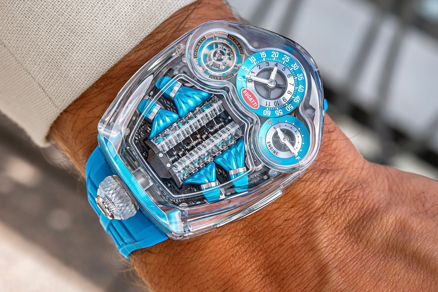 The Bugatti Tourbillon Sapphire Crystal seen from above on the wrist, showing the case outline, the sapphire crown and the louvred blue strap