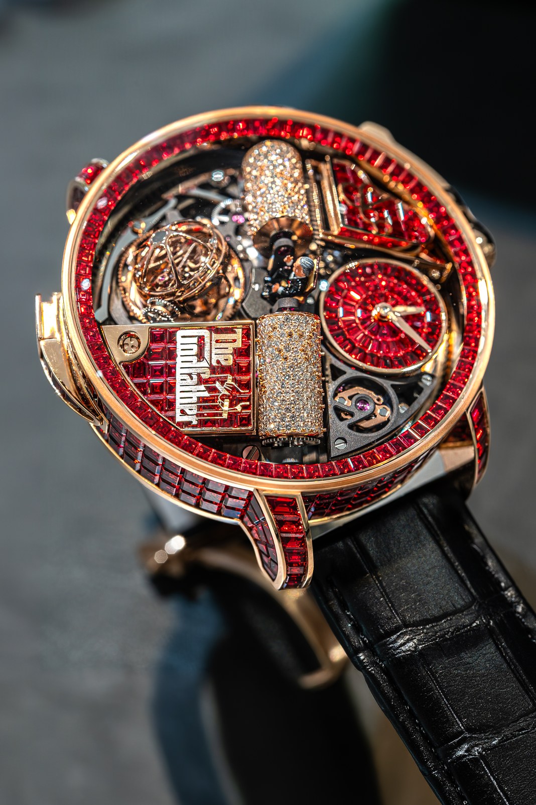 Close view of the Jacob & Co. Opera Godfather Baguette, with the Don Vito Corleone figurine, red-sapphire case, musical cylinders, rotating time display and triple-axis tourbillon