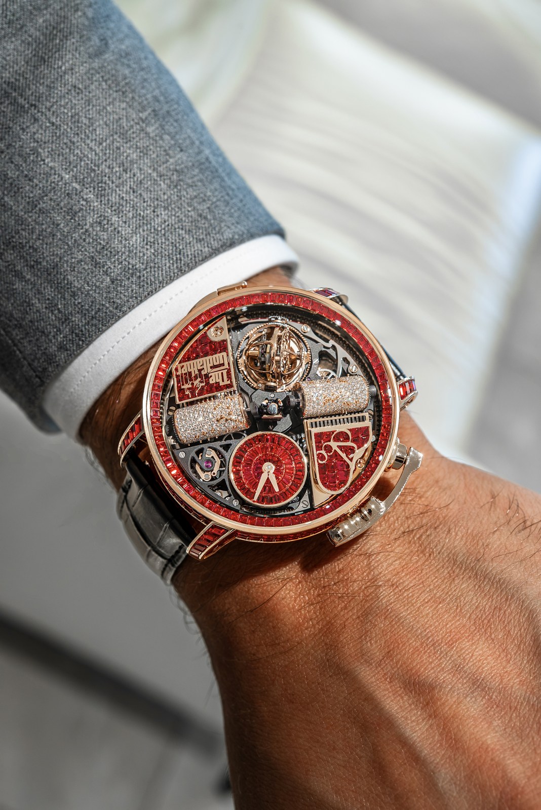 Opera Godfather Baguette rotated on a wrist, with its musical cylinders, tourbillon and red hour-and-minute display visible beneath the sapphire crystal