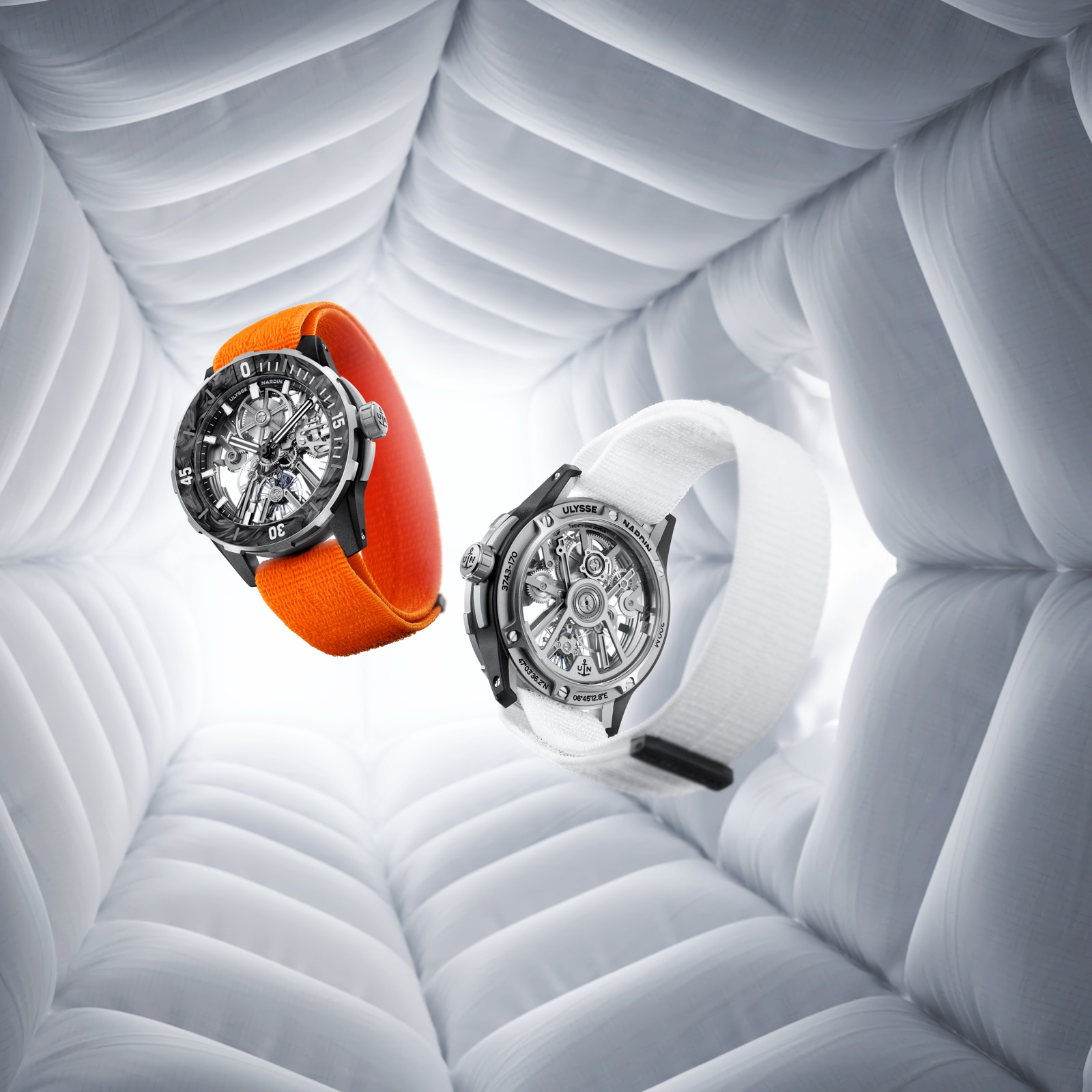 Two Diver [AIR] watches: one on the orange strap dial up, one on the white strap turned to show its caseback
